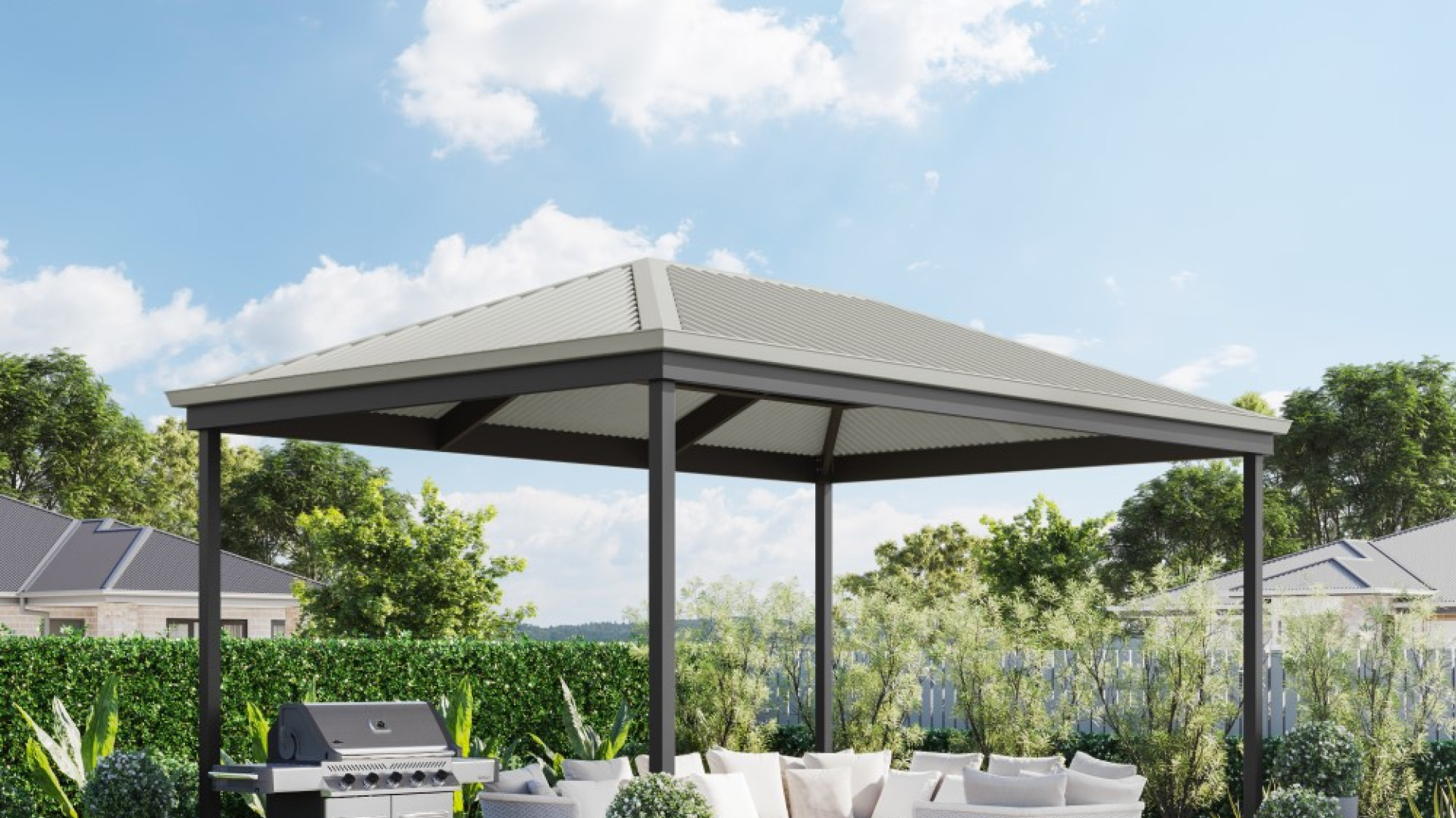 A hipped roof pergola with wooden raised decking, a BBQ and a white outdoor furniture setting