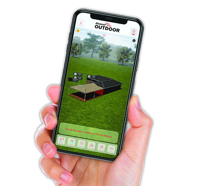 A hand holding a phone displaying a screenshot of the Stramit Outdoor Patio Designer App