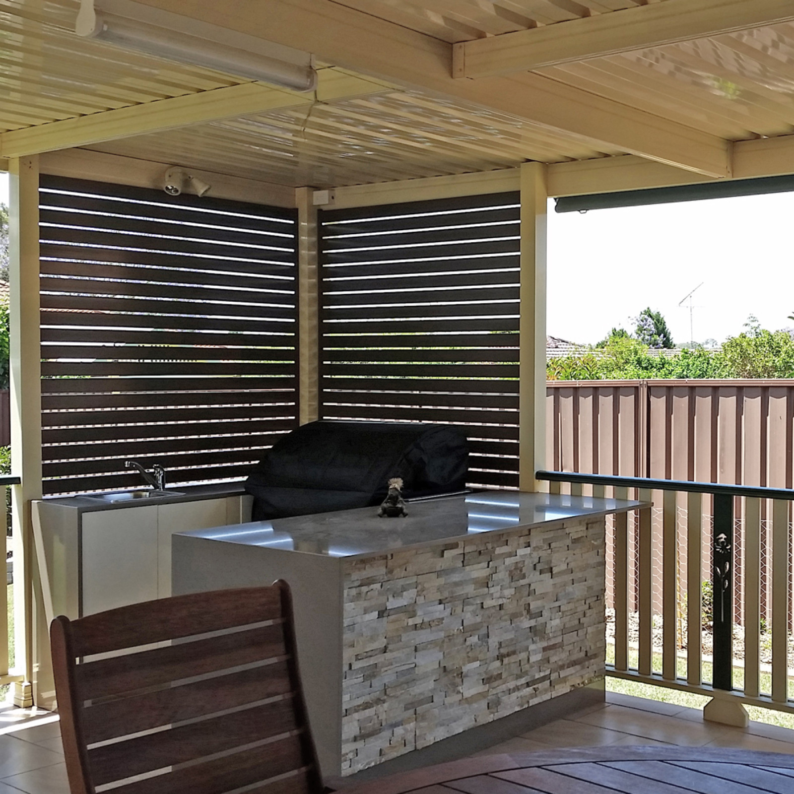 Flat roof patio covering BBQ area